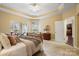 Bright main bedroom with sitting area, large windows, and an ensuite bathroom entrance at 1209 Waypoint Ct, Matthews, NC 28104