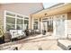 Brick patio with comfortable outdoor seating, lush plants, and ample natural light at 1209 Waypoint Ct, Matthews, NC 28104