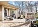 Outdoor living on a brick patio with seating, a grill, and a serene wooded backdrop at 1209 Waypoint Ct, Matthews, NC 28104