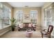 Cozy sunroom filled with natural light, a decorative bench, and serene views of the outdoors at 1209 Waypoint Ct, Matthews, NC 28104