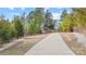 A long concrete walking trail surrounded by tall trees at 1209 Waypoint Ct, Matthews, NC 28104