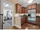 Kitchen with wood cabinets, stainless appliances, and a view to an exercise room at 1317 Wyndmere Hills Ln, Matthews, NC 28105