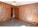 Cozy bedroom featuring wood paneling, modern flooring and a door, creating a warm and inviting space at 1433 Buffalo Shoals Rd, Catawba, NC 28609