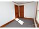 Bright bedroom showcasing light walls, wooden trim, and a pair of doors, complemented by carpet flooring at 1433 Buffalo Shoals Rd, Catawba, NC 28609