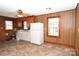 Bright kitchen with white appliances, ample counter space, wood paneling, and neutral vinyl flooring at 1433 Buffalo Shoals Rd, Catawba, NC 28609