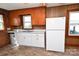 Well-lit kitchen with white cabinetry, vintage wood paneling, and a modern sink at 1433 Buffalo Shoals Rd, Catawba, NC 28609