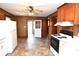 Spacious kitchen featuring white appliances, wood paneling, updated vinyl flooring, and plenty of natural light at 1433 Buffalo Shoals Rd, Catawba, NC 28609