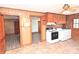 Vintage-style kitchen equipped with white appliances and wooden cabinetry with doorway access to other rooms at 1433 Buffalo Shoals Rd, Catawba, NC 28609