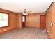 Bright living room with vinyl flooring, vintage wood paneling, and neutral ceiling fan at 1433 Buffalo Shoals Rd, Catawba, NC 28609