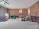 Unfinished basement with exposed brick and carpeted floors offers lots of potential at 1525 Oakridge Dr, Salisbury, NC 28146