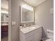 Bathroom sink vanity with grey countertop and backsplash and white basin sink at 1525 Oakridge Dr, Salisbury, NC 28146