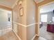 This hallway with trim features access to rooms and lovely flooring at 1525 Oakridge Dr, Salisbury, NC 28146