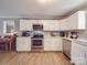 Bright kitchen boasts stainless steel appliances, white cabinets, and ample counter space at 1525 Oakridge Dr, Salisbury, NC 28146