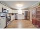 Bright and spacious kitchen with stainless steel appliances, wood-look floors, and white cabinetry at 1525 Oakridge Dr, Salisbury, NC 28146