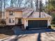 Inviting home featuring a spacious two-car garage, complemented by a lush, natural landscape at 1590 Daybreak Ridge Rd, Kannapolis, NC 28081