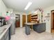 Bright kitchen with white cabinets, stainless steel refrigerator, and a cozy breakfast bar for casual dining at 1590 Daybreak Ridge Rd, Kannapolis, NC 28081