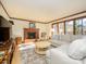 Sunlit living room showcasing a fireplace, wooden trim, and ample seating space at 1590 Daybreak Ridge Rd, Kannapolis, NC 28081