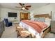 Spacious main bedroom with a ceiling fan, TV and adjacent doors to the bathroom at 1590 Daybreak Ridge Rd, Kannapolis, NC 28081