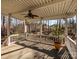 A covered back porch provides relaxing views of the wooded backyard at 1590 Daybreak Ridge Rd, Kannapolis, NC 28081