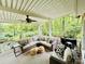 Relaxing covered back porch featuring comfortable wicker furniture, a ceiling fan and views of the surrounding trees at 1590 Daybreak Ridge Rd, Kannapolis, NC 28081