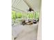 Covered back porch with comfortable wicker furniture, a ceiling fan and views of the surrounding greenery at 1590 Daybreak Ridge Rd, Kannapolis, NC 28081