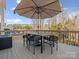 Spacious back deck with dining set and umbrella, perfect for enjoying outdoor meals and relaxation at 1630 Sassafras Ct, Fort Mill, SC 29715