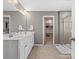 Bathroom featuring a double vanity, mirror, and a shower, complemented by ample storage space at 1630 Sassafras Ct, Fort Mill, SC 29715