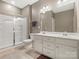 Well-lit bathroom with double vanity, a large mirror, and walk-in shower, offering style and functionality at 1630 Sassafras Ct, Fort Mill, SC 29715