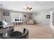 Bonus room with a ceiling fan, chairs, and a games display shelf in a comfortable setting at 1630 Sassafras Ct, Fort Mill, SC 29715