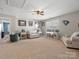 Expansive bonus room with ceiling fan, natural light, and carpet; offering flexible living space at 1630 Sassafras Ct, Fort Mill, SC 29715