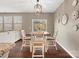 Dining area featuring wood floors, modern lighting, and view to the backyard at 1630 Sassafras Ct, Fort Mill, SC 29715