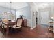 Dining room with hardwood floors, view to entry, and a modern chandelier at 1630 Sassafras Ct, Fort Mill, SC 29715