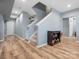 Hallway with new floors, stairs, and a white door and cabinet providing ample storage at 1630 Sassafras Ct, Fort Mill, SC 29715