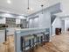 Kitchen bar with stools, stainless steel appliances, white cabinets and an accent backsplash at 1630 Sassafras Ct, Fort Mill, SC 29715