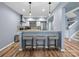 Kitchen bar with stools, stainless steel appliances, white cabinets and an accent backsplash at 1630 Sassafras Ct, Fort Mill, SC 29715