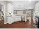 Open kitchen with stainless steel appliances, granite counters, and hardwood floors at 1630 Sassafras Ct, Fort Mill, SC 29715