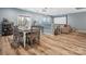 Open living space with a dining table, movie screen, and hardwood floors at 1630 Sassafras Ct, Fort Mill, SC 29715