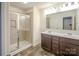 Modern bathroom showcasing a double sink vanity, a large mirror, and a glass-enclosed shower at 203 Makayla Ct, Fort Mill, SC 29715
