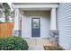 Welcoming front door with stone accents, white pillars, and a neatly trimmed front shrub at 203 Makayla Ct, Fort Mill, SC 29715