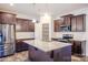 Modern kitchen features a granite island, stainless steel appliances, and dark wood cabinetry at 203 Makayla Ct, Fort Mill, SC 29715