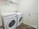 Convenient laundry room equipped with a modern washer and dryer on wood look floors at 203 Makayla Ct, Fort Mill, SC 29715