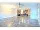 Open-concept living room showcasing wood flooring, a ceiling fan, and a glimpse of the modern kitchen at 203 Makayla Ct, Fort Mill, SC 29715
