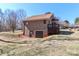 Spacious home featuring a brick exterior, a brown roof, a wooden deck, and a basement garage at 2274 Old Wilkesboro Rd, Statesville, NC 28625