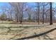 The large lawn has dormant grass and trees around the perimeter with a small bird bath in the center at 2274 Old Wilkesboro Rd, Statesville, NC 28625