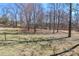 The lawn is expansive and has a small bird bath in the center with a wooded perimeter around the yard at 2274 Old Wilkesboro Rd, Statesville, NC 28625