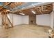 Spacious unfinished basement with brick fireplace and open ceiling at 2274 Old Wilkesboro Rd, Statesville, NC 28625