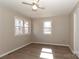 Neutral bedroom features a ceiling fan, wood-look flooring, and double-hung windows at 2274 Old Wilkesboro Rd, Statesville, NC 28625