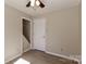 Bedroom offers wood-look flooring and a door leading to an unfinished space at 2274 Old Wilkesboro Rd, Statesville, NC 28625