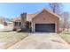 Charming brick home featuring a stone chimney, attached garage and cozy front yard at 2274 Old Wilkesboro Rd, Statesville, NC 28625