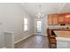 Bright kitchen with a chandelier, wood cabinets, and updated flooring at 2274 Old Wilkesboro Rd, Statesville, NC 28625